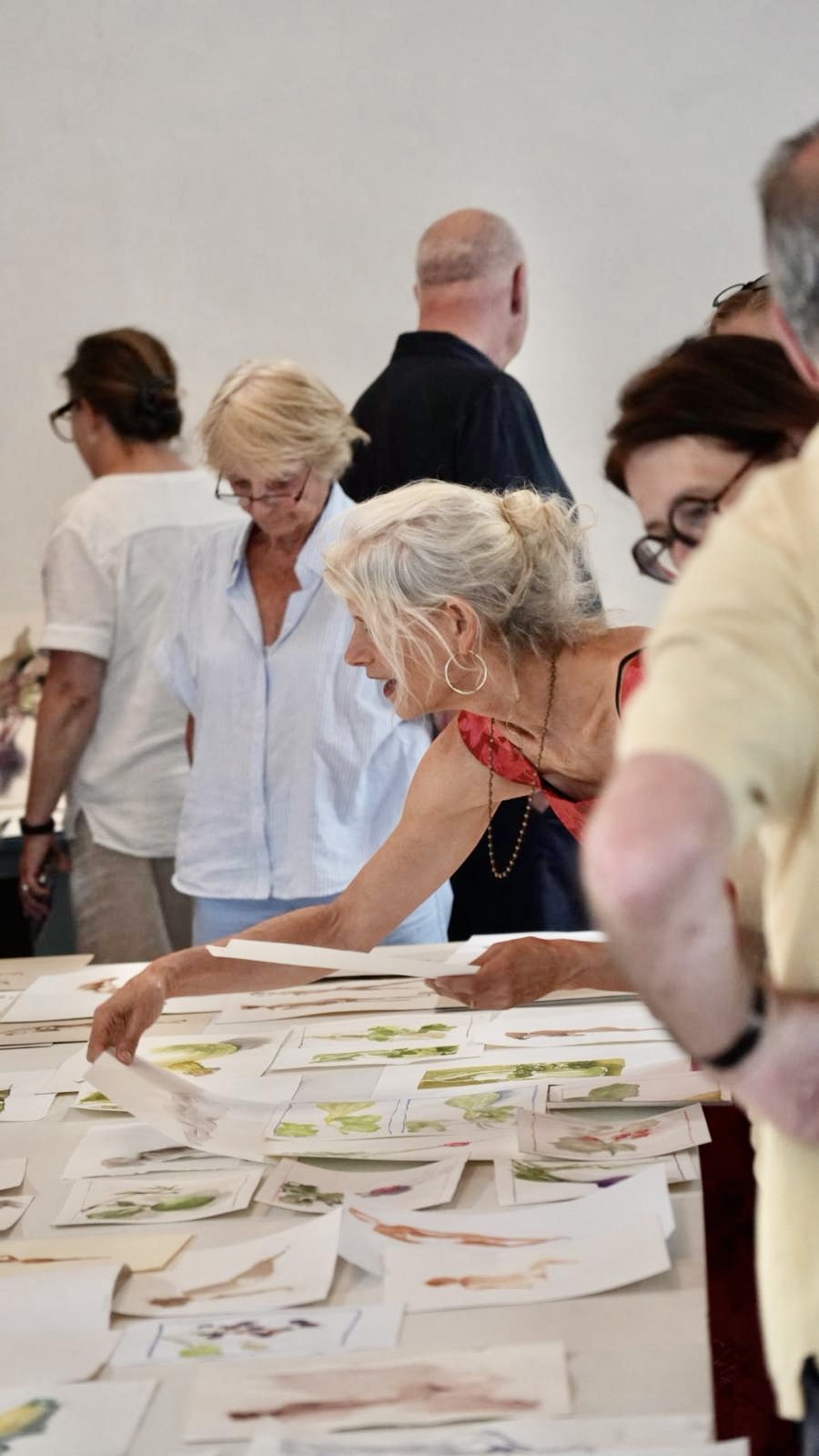 Wendy Artin looking at group artwork.