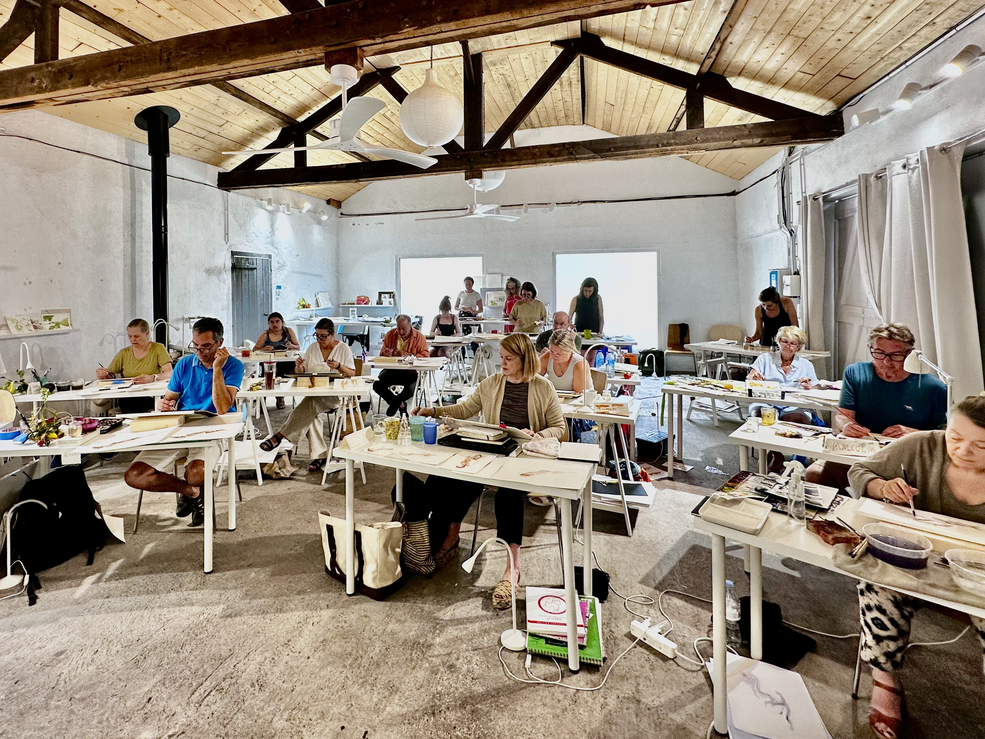 Group painting at desks in Atelier at Clos Mirabel.