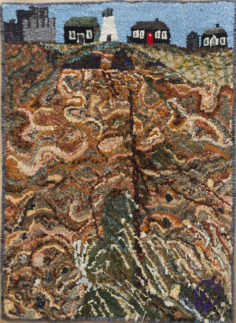 Hooked rug design of landscape and houses.