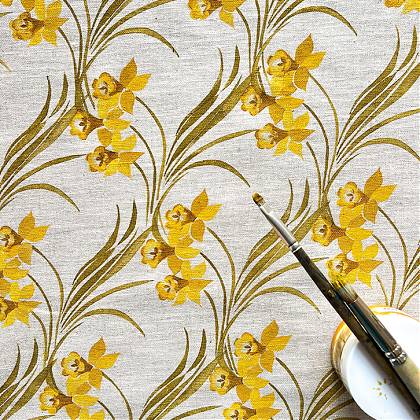 Daffodil stencil print repeat on cream fabric.