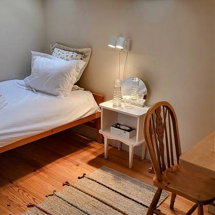 Single bed with side table.