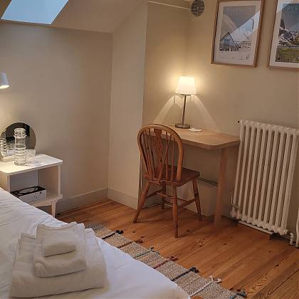 Small bedroom with a desk and chair.