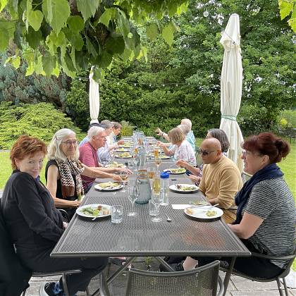 Group having dinner on the terrace - writers retreat.