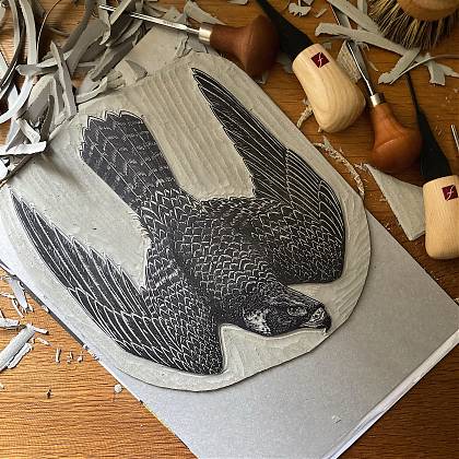 Lino cut carving in progress of a hawk by tutor Emily Robertson