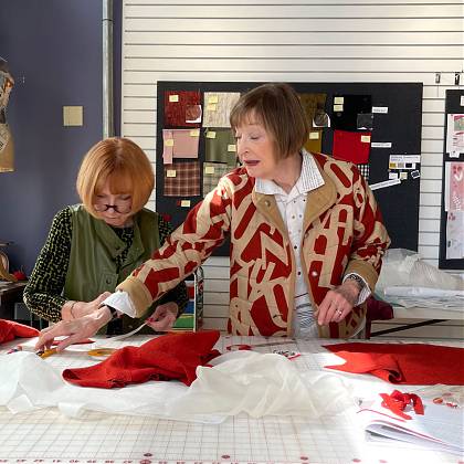 Two women at cutting table.
