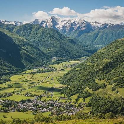 View of the Vallée d'Ossau, snow capped mountains, valley and village.