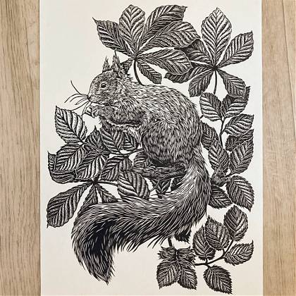 Black on white print of a squirrel in leaves by lino cut tutor and artist Emily Robertson.