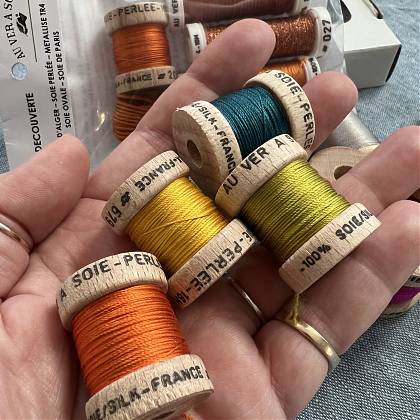 Reels of colourful threads for embroidery project.
